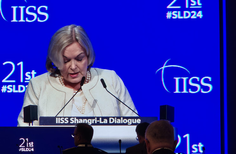 New Zealand Minister of Defence Judith Collins addressing the dialogue from a podium